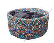 Circular, fluffy cat bed with an African print.